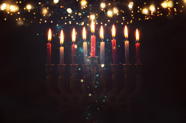 Image of jewish holiday Hanukkah background with menorah (traditional candelabra) and burning candles.