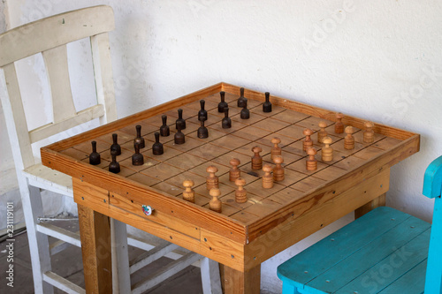 Morning shoot of wooden big size checkerswith blue and white chair photo