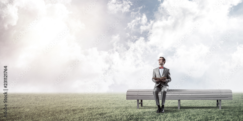 Young businessman or student studying the science in summer park