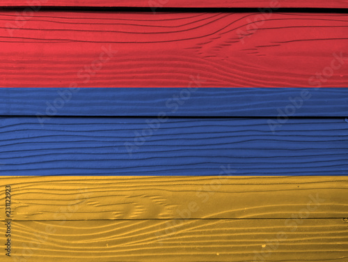 Flag of Armenia and Barbuda on wooden wall background. Grunge Armenian flag texture, a horizontal tricolor of red, blue, and orange.