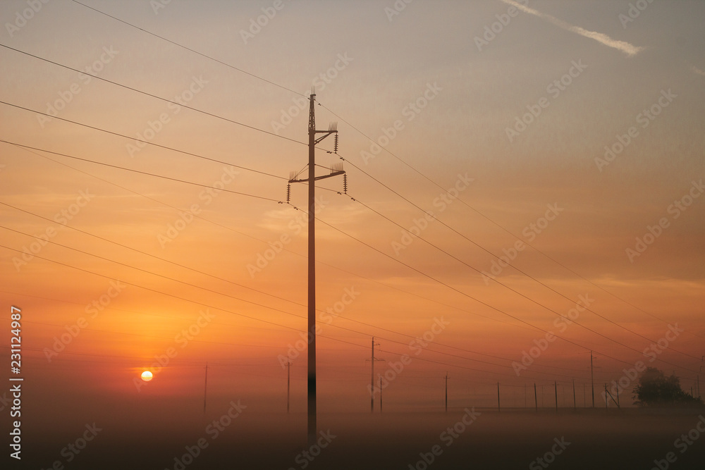Power line in fog in the early morning