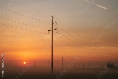 Power line in fog in the early morning © Svetlana