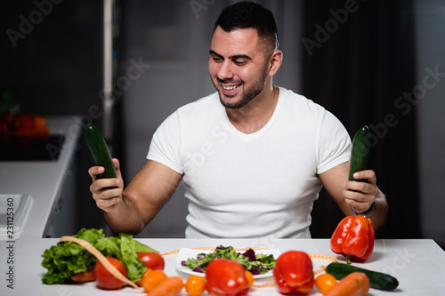 Beautiful man to eat healthy vegetarian food at home. The concept of a healthy lifestyle