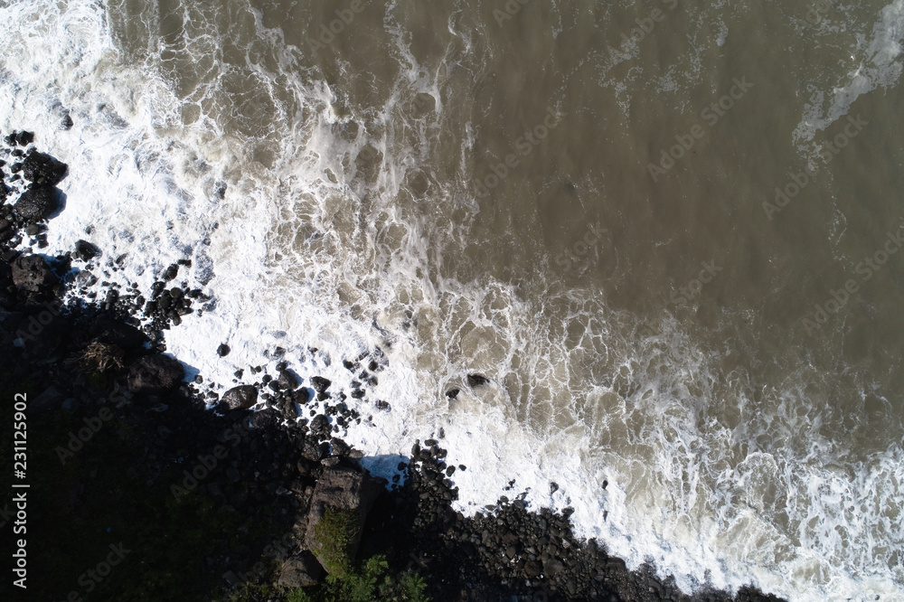 Sea waves and stony shore are photographed from above. Sea waves and stony shore are photographed from above.