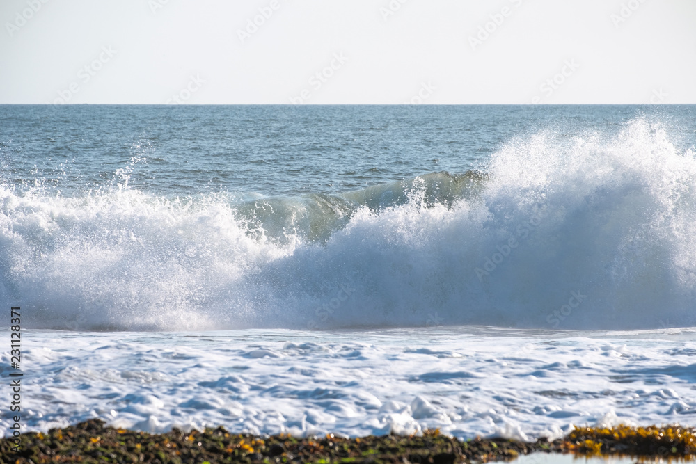 Wave crashing on coastline