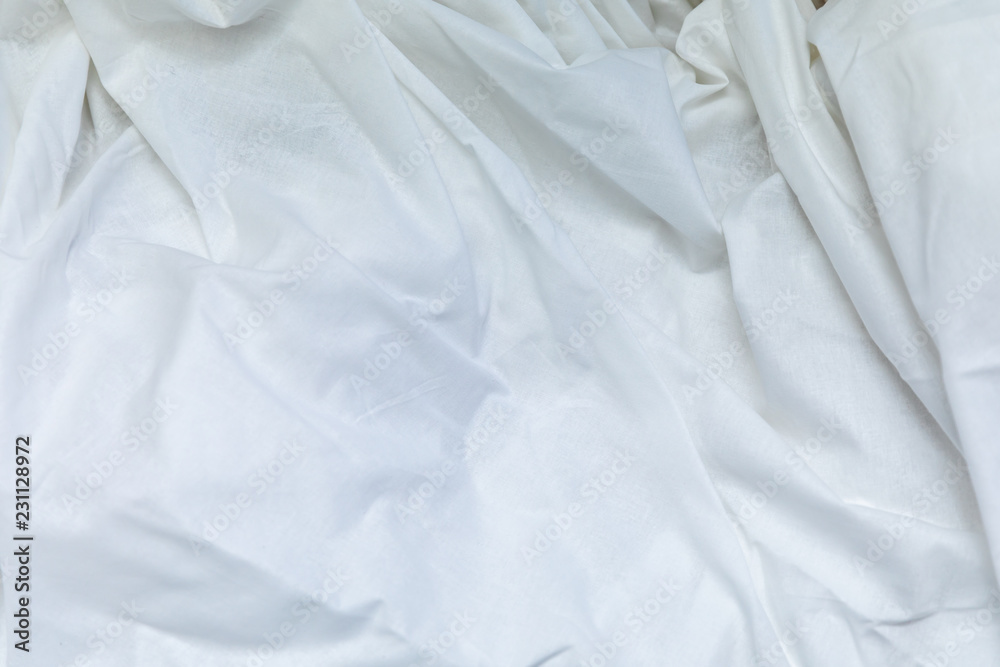Top view of the crease of an unmade bed sheet in the bedroom after a long night sleep and waking up in the morning. Top view of the crease of an unmade bed sheet in the bedroom after a long night sleep and waking up in the morning.