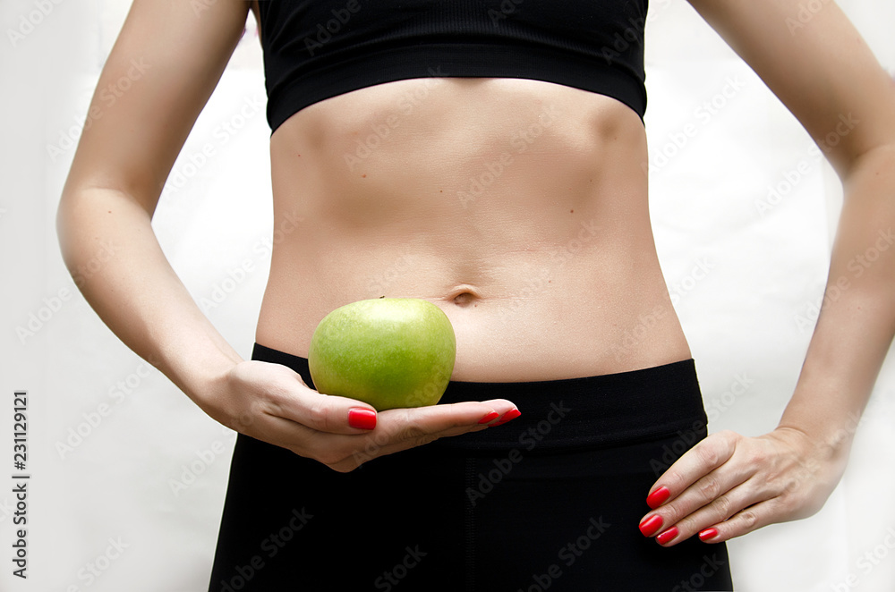 girl in uniform holding a green Apple in her right hand on white background girl in uniform holding a green Apple in her right hand on white background