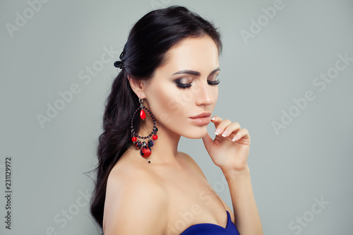 Perfect brunette woman with makeup and jewelry