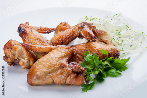 Grilled chicken wings on a white plate