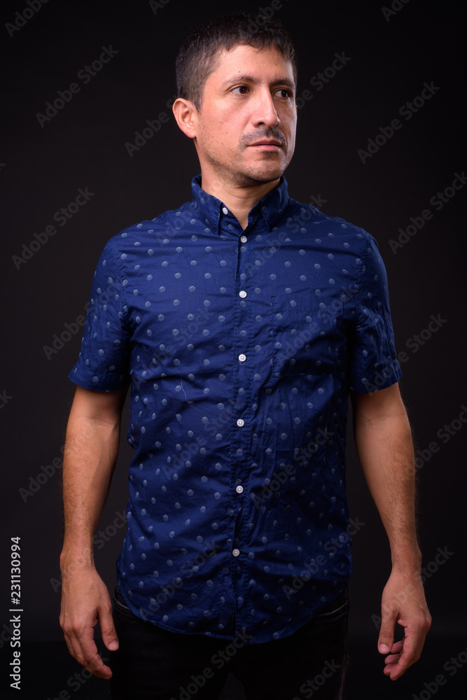 Portrait of Hispanic businessman against black background Portrait of Hispanic businessman against black background
