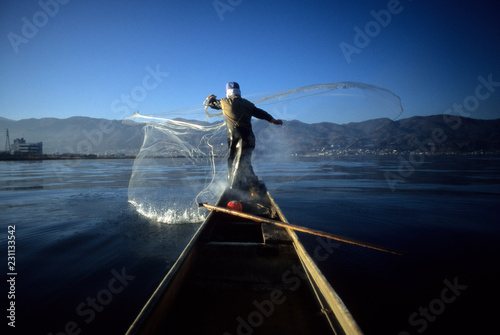 Fisherman casting net photo