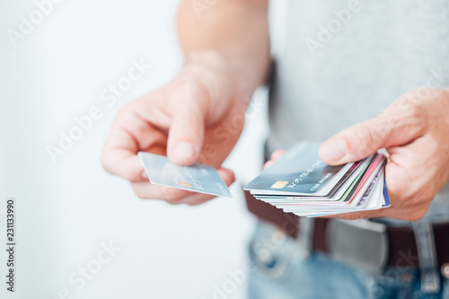 shopping discount or loyalty cards. modern marketing business. man holding a selection of plastic cards. photo