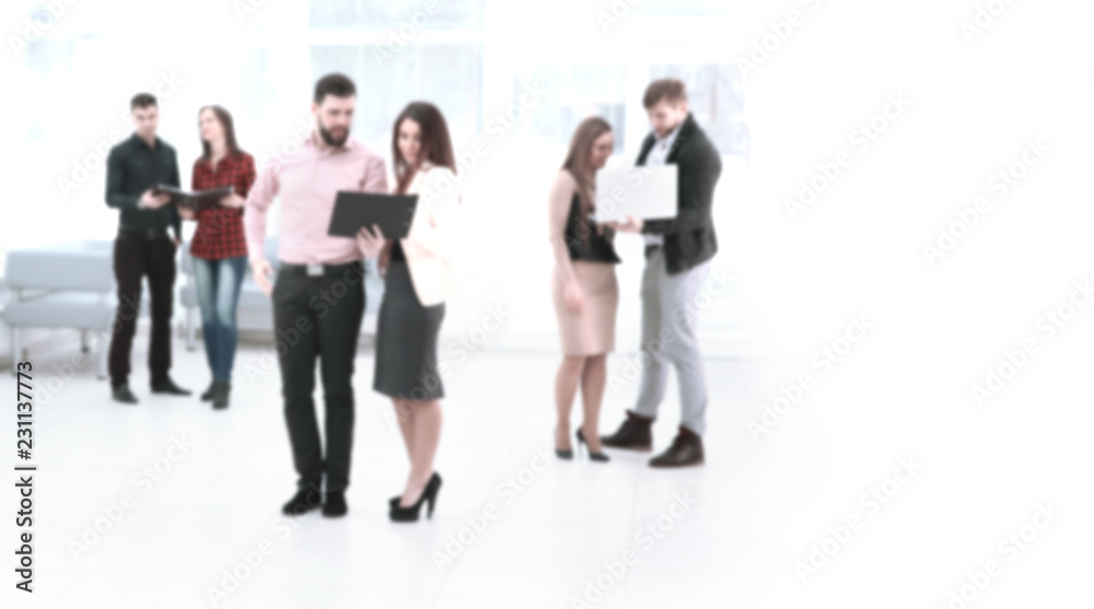 blurred image of a group of business people talking in the offic blurred image of a group of business people talking in the offic