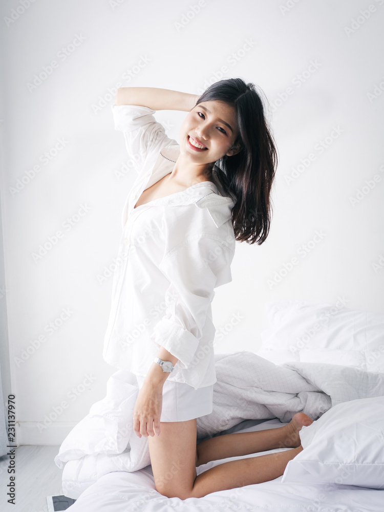 Happy Asian woman relaxing on bed, lifestyle concept. Happy Asian woman relaxing on bed, lifestyle concept.