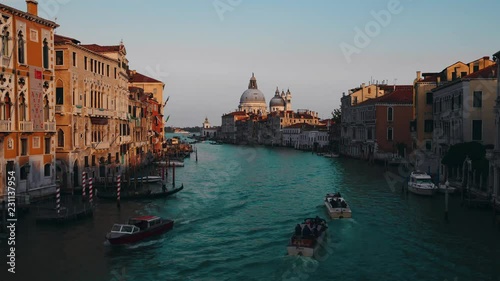 4K time lapse of beautiful view of gondolas, water taxis, and vaporetto passing by a beautiful cathedral on the Grand Canal in Venice, Italy, Europe