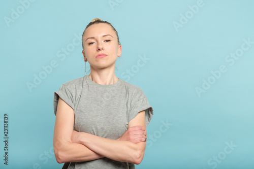 confident serious woman with crossed arms. look of defiance and self assurance.