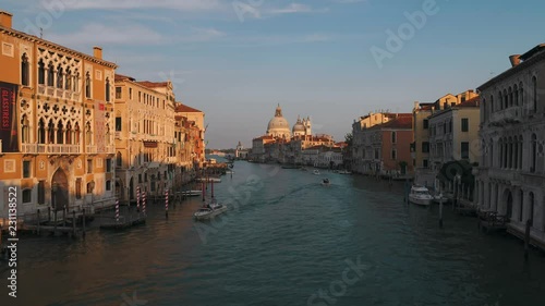 4K time lapse of beautiful view of gondolas, water taxis, and vaporetto passing by a beautiful cathedral on the Grand Canal in Venice, Italy, Europe