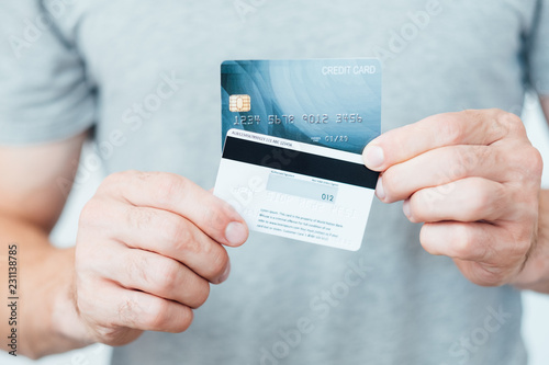 credit card CVC2 code. digital transaction safety. man holding plastic cards. photo