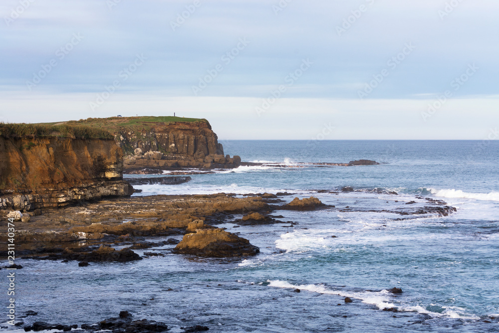 View on Curio Bay, the southernmost point of the Catlins, New Zealand. Beautiful abandoned environment with a great outlook on Porpoise Bay, the sea and the cliffs View on Curio Bay, the southernmost point of the Catlins, New Zealand. Beautiful abandoned environment with a great outlook on Porpoise Bay, the sea and the cliffs
