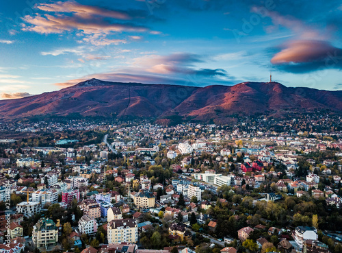 Beautiful drone shot of a vivid sunrise over Sofia, Bulgaria - impressive image with colourful skies and amazing aerial views over the city.