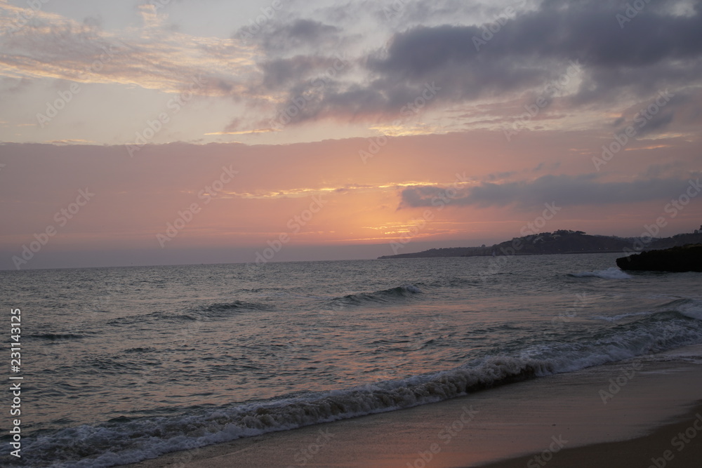 Ocean in the evening. Sunset over the waves. Clouds and bright colors of the evening sky. Orange red azure Ocean in the evening. Sunset over the waves. Clouds and bright colors of the evening sky. Orange red azure