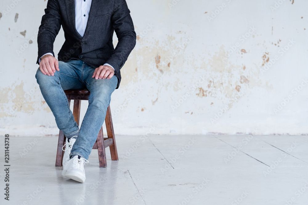 man in jacket and jeans sitting on a chair. confident business trainer or  entrepreneur. smart casual dress code. Stock Photo | Adobe Stock