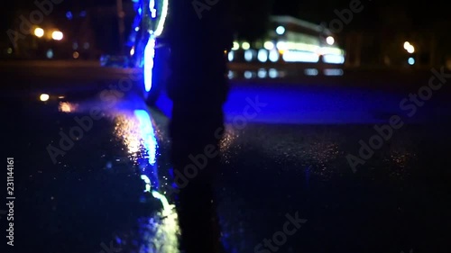 Glowing bicycle is reflected in the water. Props for Halloween. Wheel close up. photo