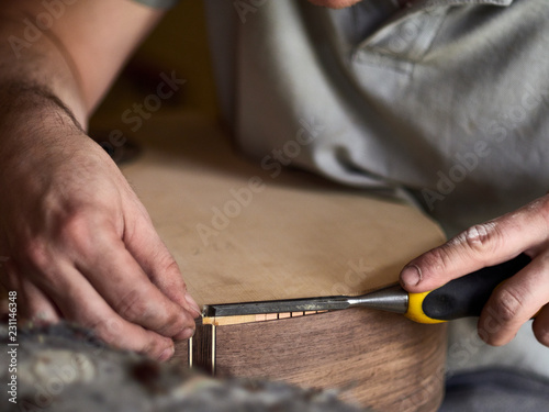 Luthier Install Binding on an guitar.