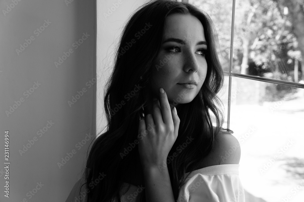 beautiful girl around the window looking in the window. beautiful girl around the window looking in the window.