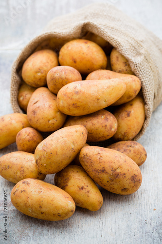 A bio russet potato wooden vintage background.