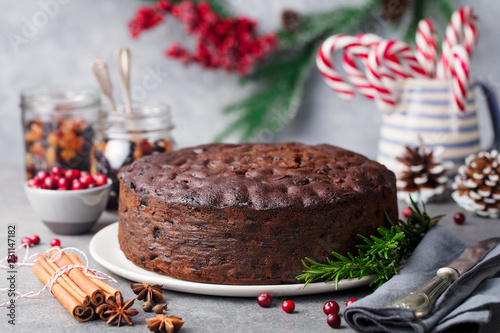 Christmas fruit cake, pudding on white plate. Copy space. Close up.