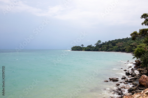 Tropical sea landscape with turquoise blue water and stone shore. Peaceful landscape of exotic paradise.