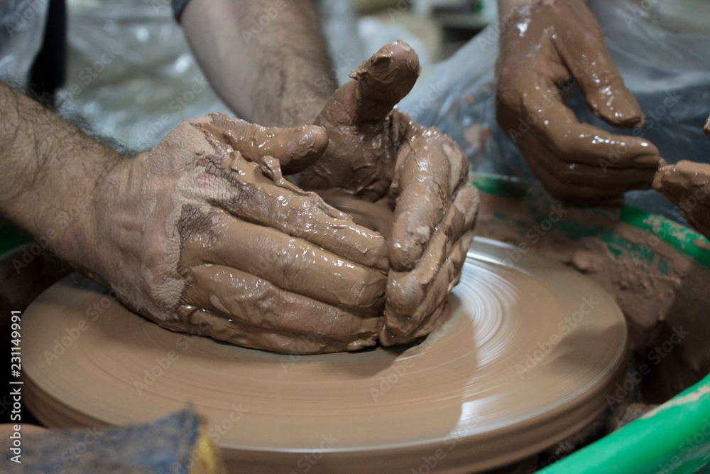 hands of a experienced master potter from Bulgaria with 14 years experience which teaches the art of making pots of clay on the potter's wheel. Reportage photography