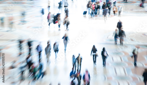 Abstract image of city commuters. High key intentional blur of crowd of unrecognizable people walking in the city. Bleached effect. Concept for business, shopping, modern life, corporate, future