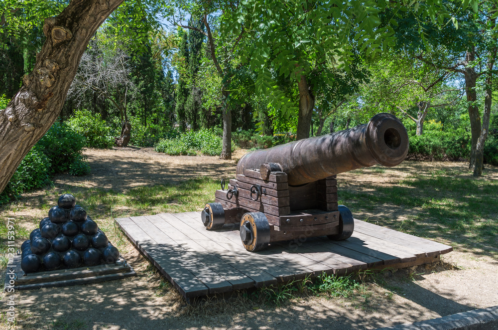 Old muzzle-loading gun. Russia, the Republic of Crimea, the city of Sevastopol. 06/12/2018: Old cast-iron ship cannon in the park on Historical Boulevard