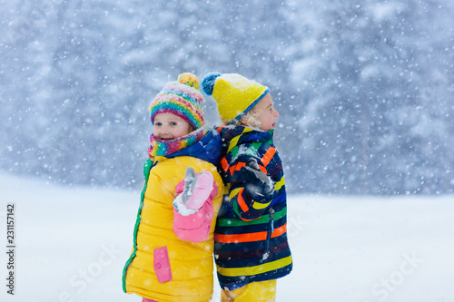 Kids playing in snow. Children play in winter.