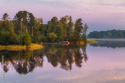 Morning landscape on a lake with islands and pine trees