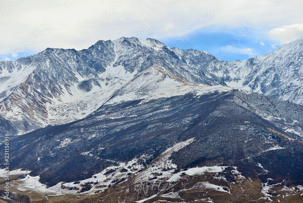 Rocky snow-capped mountains over the village of Fiagdon in North Ossetia. Rocky snow-capped mountains over the village of Fiagdon in North Ossetia.