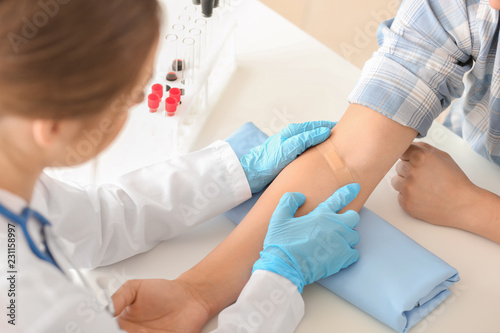 Doctor sticking adhesive pl...