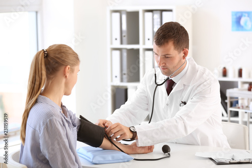 Male doctor measuring blood...