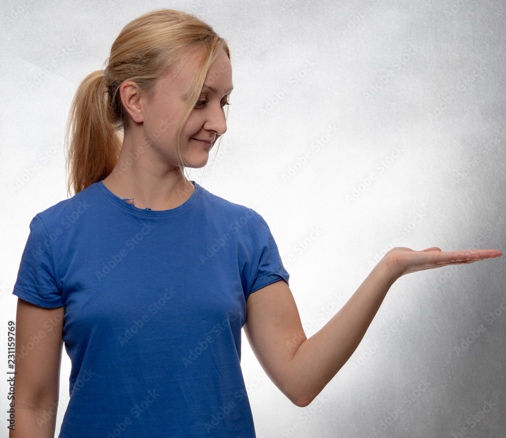 young woman in blue casual shirt with open hand young woman in blue casual shirt with open hand
