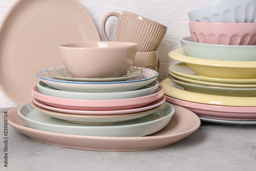 Set of clean dishware on grey table Set of clean dishware on grey table