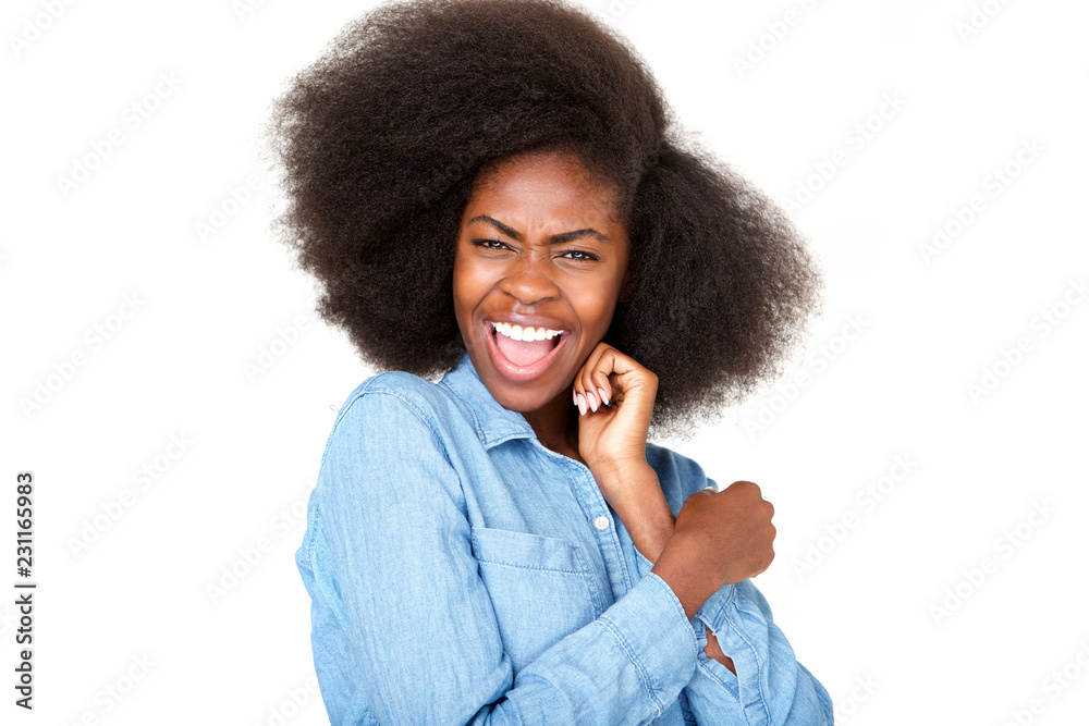 Close up happy young african american woman laughing against isolated white background Close up happy young african american woman laughing against isolated white background