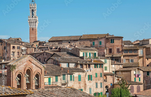 Beautiful cityscape with towers and old homes of Siena, Tuscany. Tile roofs of Italy. UNESCO World Heritage Site