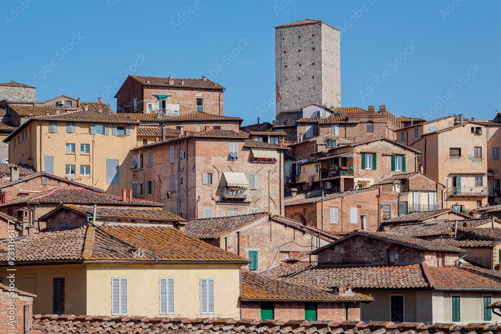 Many houses of Siena, Tuscany. Tile roofs and brick structures in Italy. UNESCO World Heritage Site