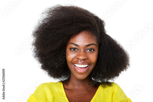 Close up happy young african american woman with afro hair laughing against isolated white background