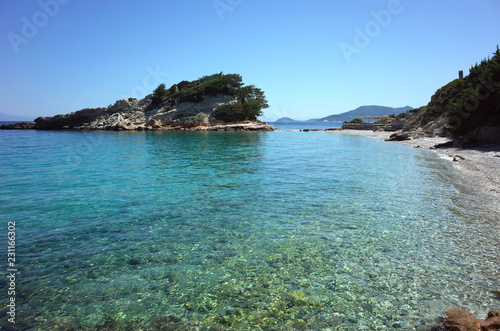 Picturesque turquoise clear water and beautiful small island in Aegean Sea near Kokkari village on Samos Island, Greece