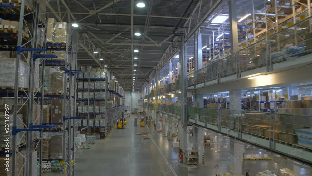 Huge warehouse and forklifts, racks with goods Huge warehouse and forklifts, racks with goods