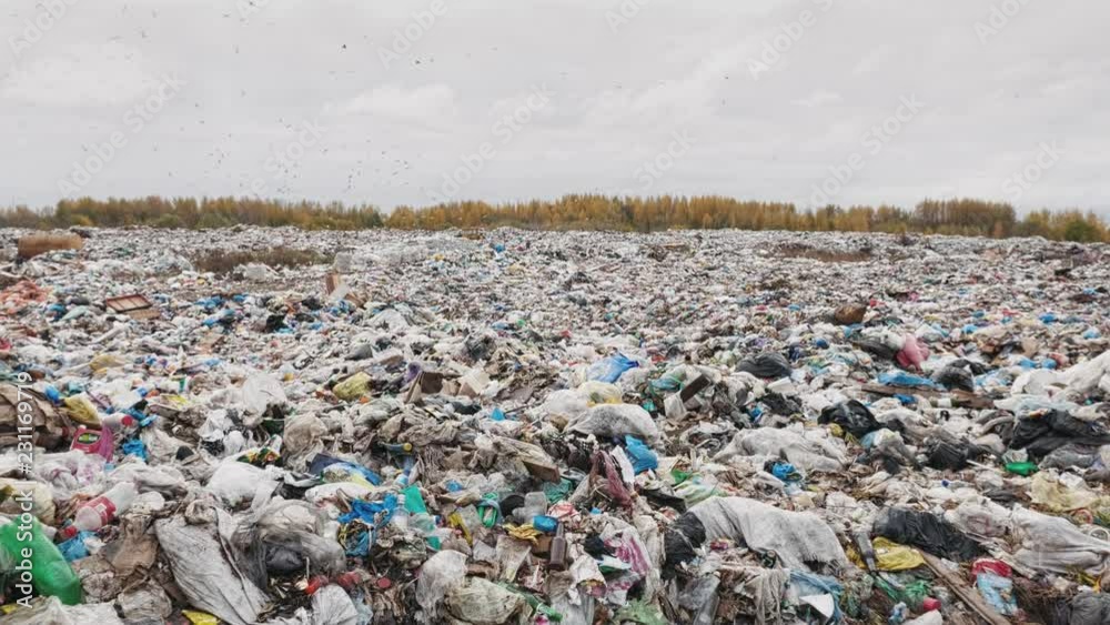 Handheld shot of city garbage dump, environmental pollution due to lack of recycling technology Handheld shot of city garbage dump, environmental pollution due to lack of recycling technology