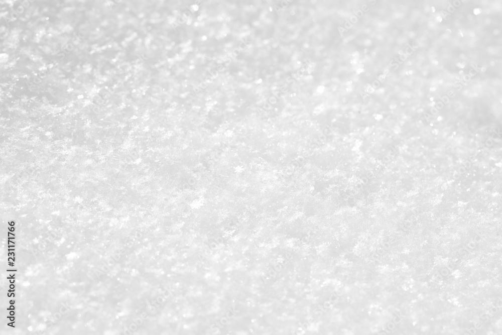 White snow texture, small sparkling snowflakes, macro. Background light gray for the New Year holidays or greeting cards.